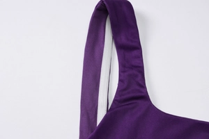 Detail of deep purple floral dress showing durable shoulder straps and inner stitching