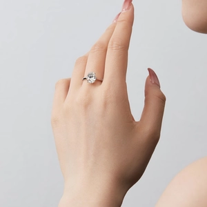 Macro detail of an elegant S925 sterling silver ring with a large oval gemstone on a finger