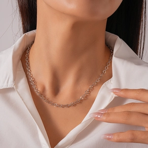 Detail of silver geometric circle necklace with hammer texture on a model