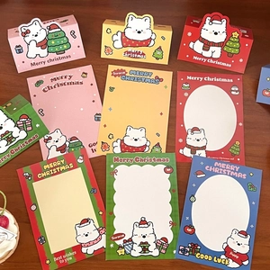 Flat lay of cute cartoon puppy Christmas greeting cards and decorative paper packaging
