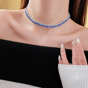 Detail of a double-layer blue tennis choker necklace featuring silver-toned crystal settings