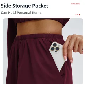 Deep burgundy sports pants featuring a functional side pocket for a smartphone and elastic waist