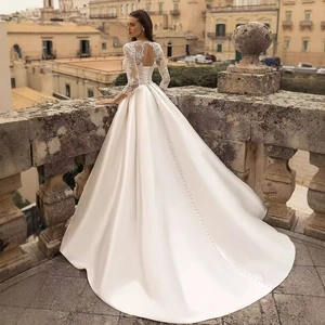 Elegant long sleeve satin wedding dress with lace back cutout and sweeping train