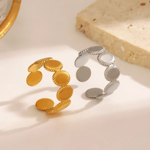 Oval geometric 18K gold and silver plated stainless steel rings on stone props