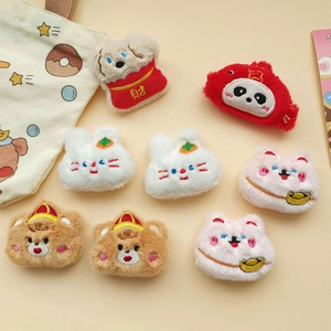 Detailed view of assorted plush animal brooches including puppy and rabbit with embroidery