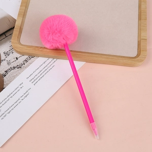 Close-up of pink fluffy pompom pen on a wooden tray with a minimalist aesthetic background