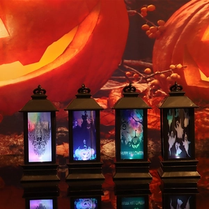 Set of four black Halloween decorative lanterns with glowing spooky pumpkin and skull patterns
