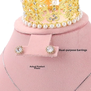 Macro shot of gold-plated stud earrings with round zircon and pink velvet crown display