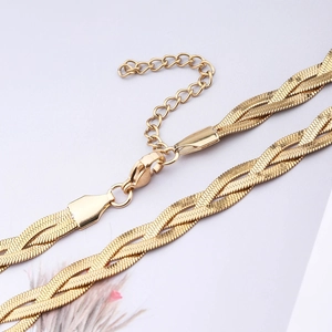 Detail view of woven gold stainless steel blade snake chain with lobster clasp