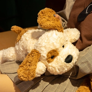 Close-up of soft curly plush puppy pillow showing fluffy texture and brown ears