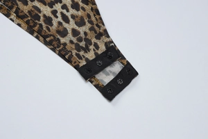 Close-up of leopard print bodysuit showing snap button closure and fabric texture
