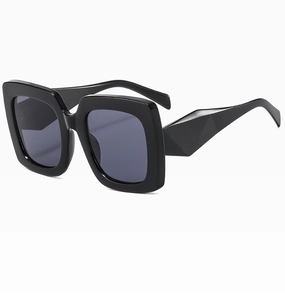 Detail of square sunglasses with geometric faceted temples and thick black resin frames