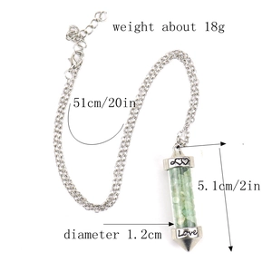 Detail view of crystal wish bottle necklace with green stone chips and Love engraving