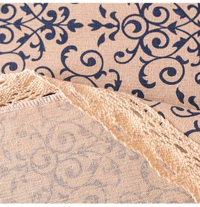 Macro shot of navy blue vintage pattern on beige linen fabric with cream lace trim