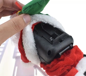 Detailed close-up showing the bottom battery compartment and power switch of the Santa toy