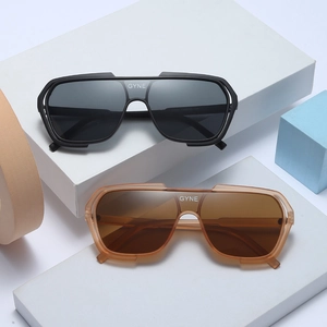 Fashionable pilot-style cycling sunglasses in black and amber colors with GYNE logo