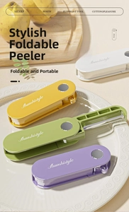 Four colors of portable folding vegetable peelers displayed on a plate in a kitchen setting