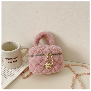 Detailed view of pink plush quilted crossbody bag with golden rose zipper charm and chain