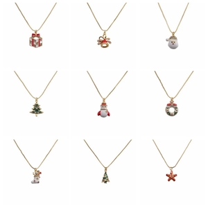 Collection of nine gold Christmas necklaces featuring gift box, bells, and Santa pendants