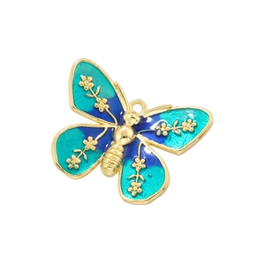 Golden butterfly pendant with blue enamel and floral patterns on a white background