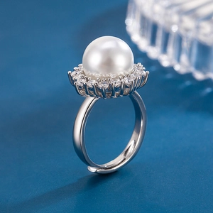 Macro shot of a sunflower ring with a large pearl center surrounded by zircon stones