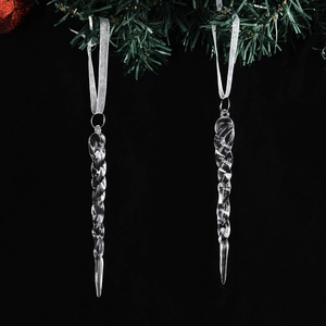 Close-up of clear acrylic spiral snowflake pendants hanging on a Christmas tree branch