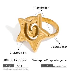 Detail view of golden stainless steel ring dimensions with star and swirl engravings