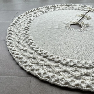 Detail of 48-inch white knitted Christmas tree skirt with diamond texture and tie closures