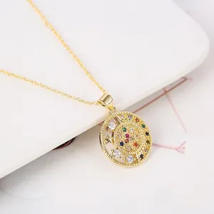 18K gold-plated necklace with colorful zircon celestial mandala pendant on a white plate