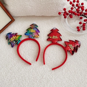 Close-up of two Christmas headbands with shiny sequins and Merry Christmas text