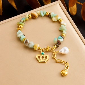 Handmade beaded bracelet with natural stones, irregular pearls, and gold crown charms