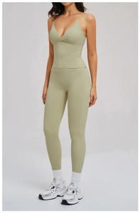 Detail of sage green yoga set with thin straps V-neck top and high waist leggings
