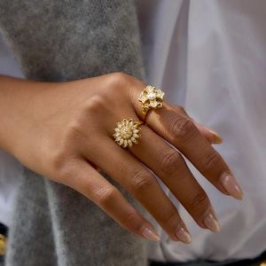 Luxurious gold rotatable rings featuring sunflower and floral designs with crystal stones