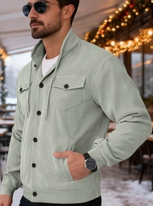 Detailed view of the fine-ribbed corduroy texture and buttoned pockets on this green jacket
