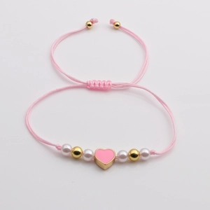 Pink woven rope bracelet with heart enamel pendant, faux pearls and golden beads