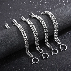 Macro detail of silver curb chain bracelets with spring ring clasps on display
