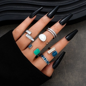 Detail view of 7-piece minimalist silver metal ring set with colorful enamel and zircon