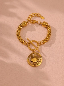 Detailed macro view of 18K gold-plated chunky chain bracelet with rooster coin and OT clasp