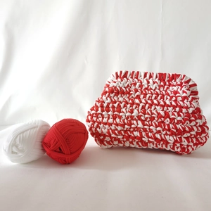 Handmade red and white t-shirt yarn crochet cloud bag with textured weave on white fabric