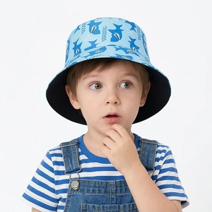 Close-up of kids bucket hat with light blue cartoon shark and water wave print patterns