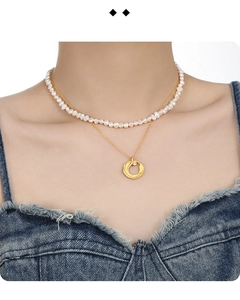 Detailed view of layered S925 silver necklace set with white pearls and gold round pendant