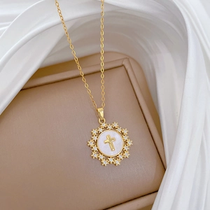 Gold star cross pendant necklace with mother of pearl and diamonds in a beige gift box