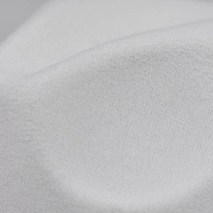 Close-up macro detail of the thick white woolen felt material texture on a fedora hat