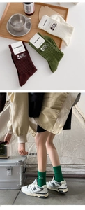 Detail of combed cotton camping socks featuring vintage outdoor embroidery in various colors