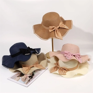 Women's wide brim straw hats with pearls and bow in various colors for beach sun protection