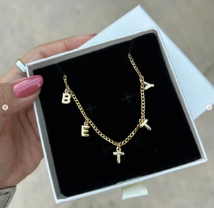 Golden bubble letter pendants BETY on chain inside a luxury white gift jewelry box