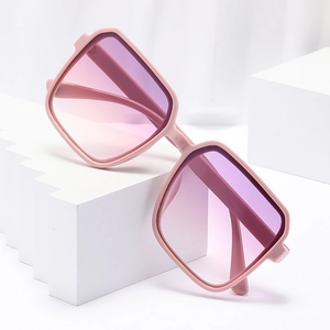 Fashionable pink square frame sunglasses with gradient purple lenses on a white pedestal
