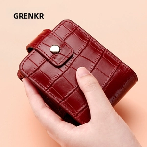 Close-up of wine red crocodile pattern leather lipstick pouch with silver metal snap button