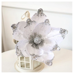 Detailed view of a white velvet Christmas flower with shimmering silver glitter accents