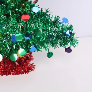 Close-up of green and red glitter tinsel Christmas tree ornament with colorful sequins